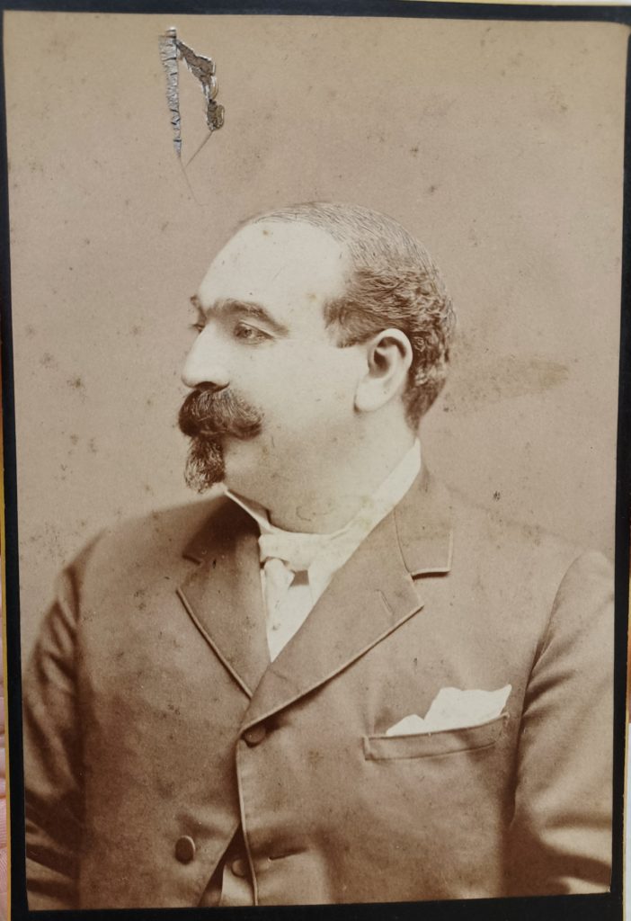 Sepia tone portrait of Mariano Edward Gonzalez. In the portrait, Gonzalez's face is in profile and he is wearing a suit.