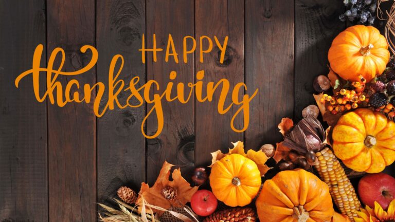 happy thanksgiving on a background image with pumpkins and fall leaves