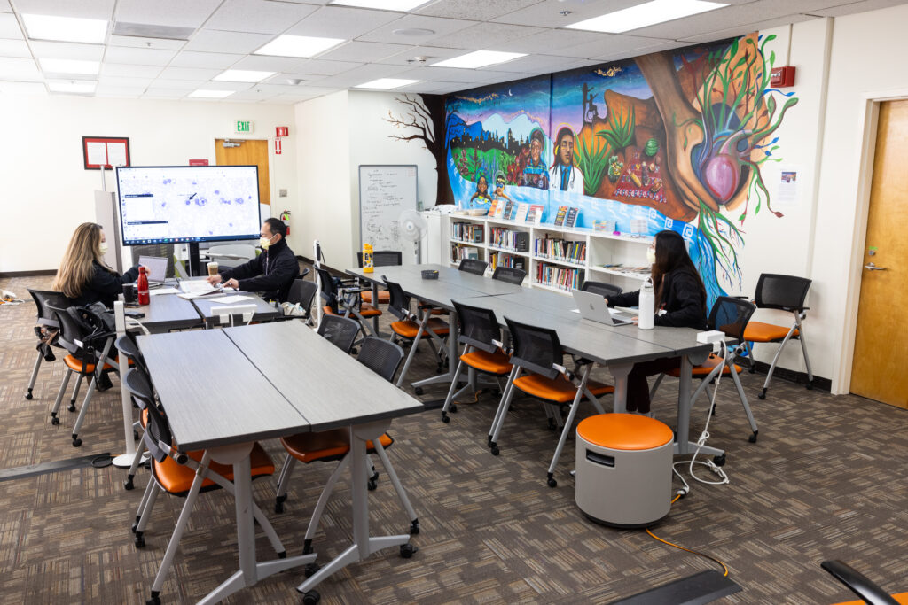 View of D-CORE space showing tables and people meeting